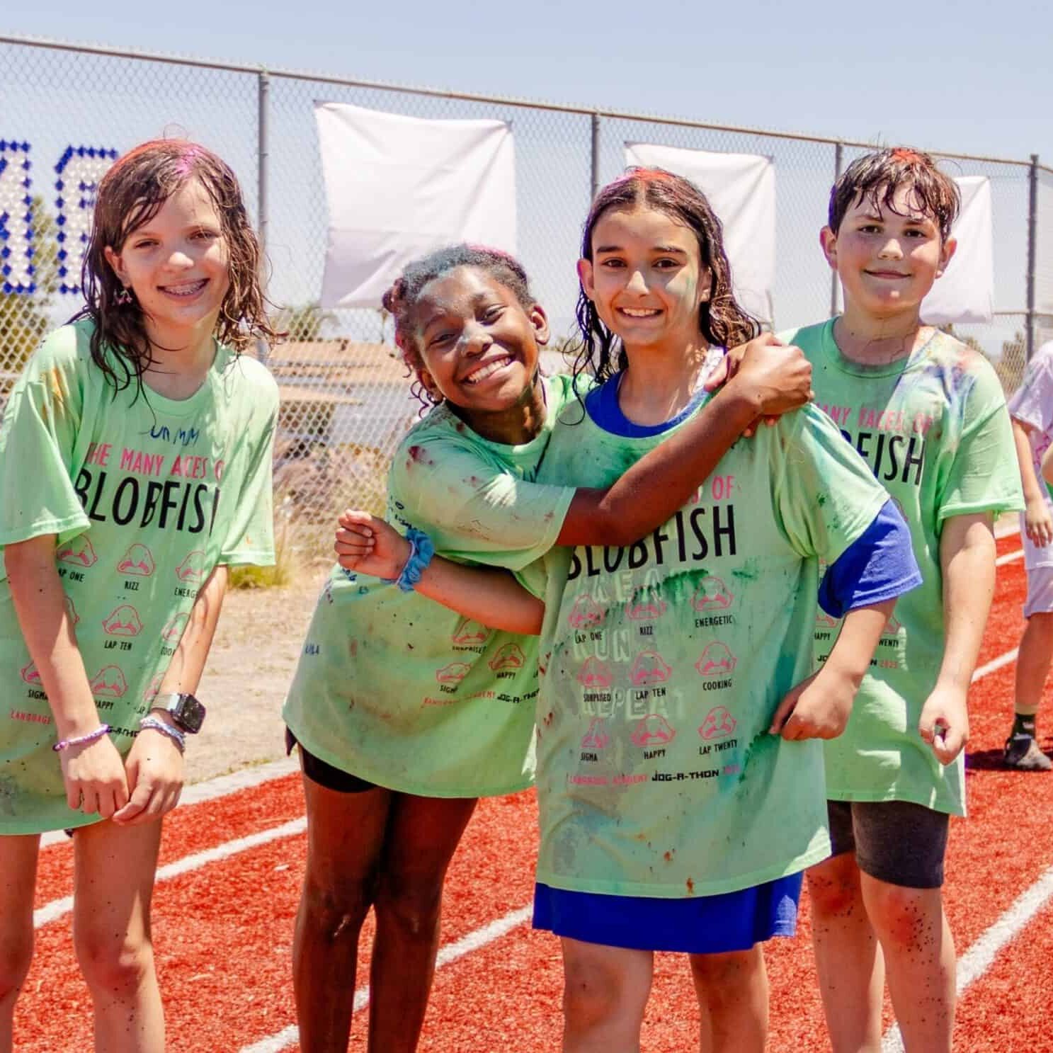 Language Academy students pose together on the track during the Jog-a-thon run.